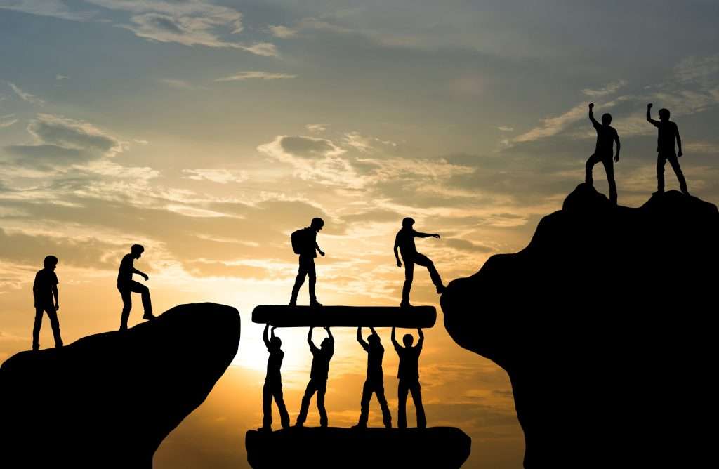 group of people on peak mountain climbing helping team work , travel trekking success business concept