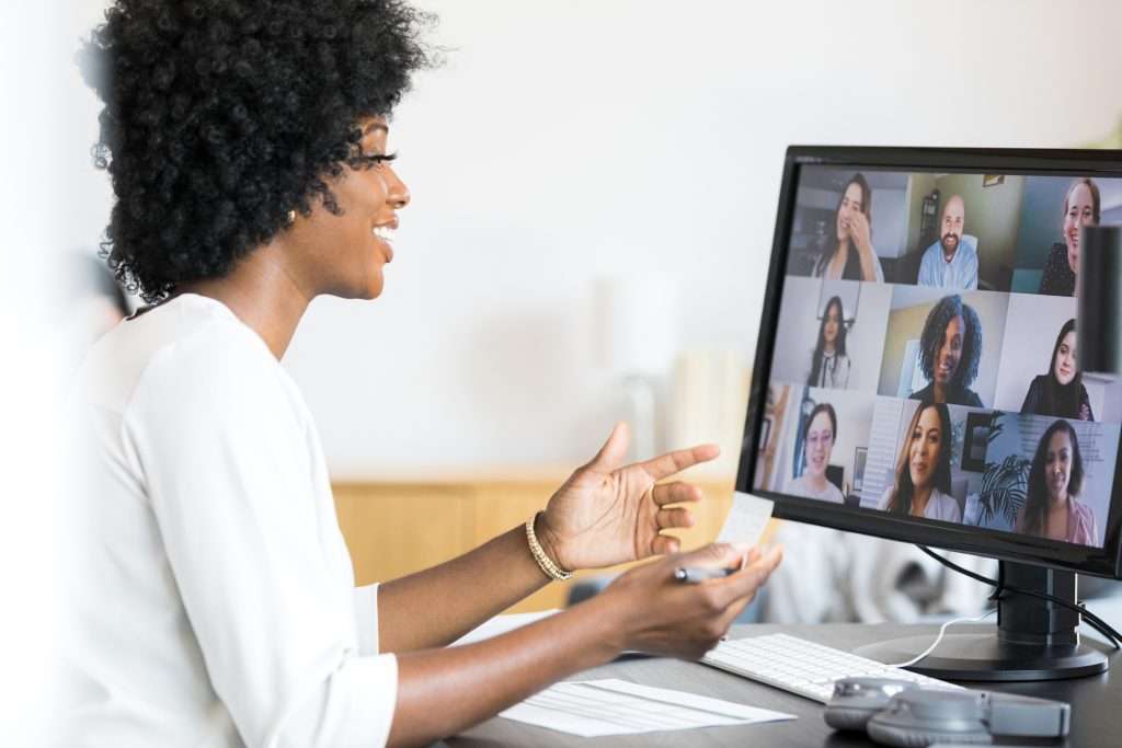 female financial advisor gestures during meeting with company employees